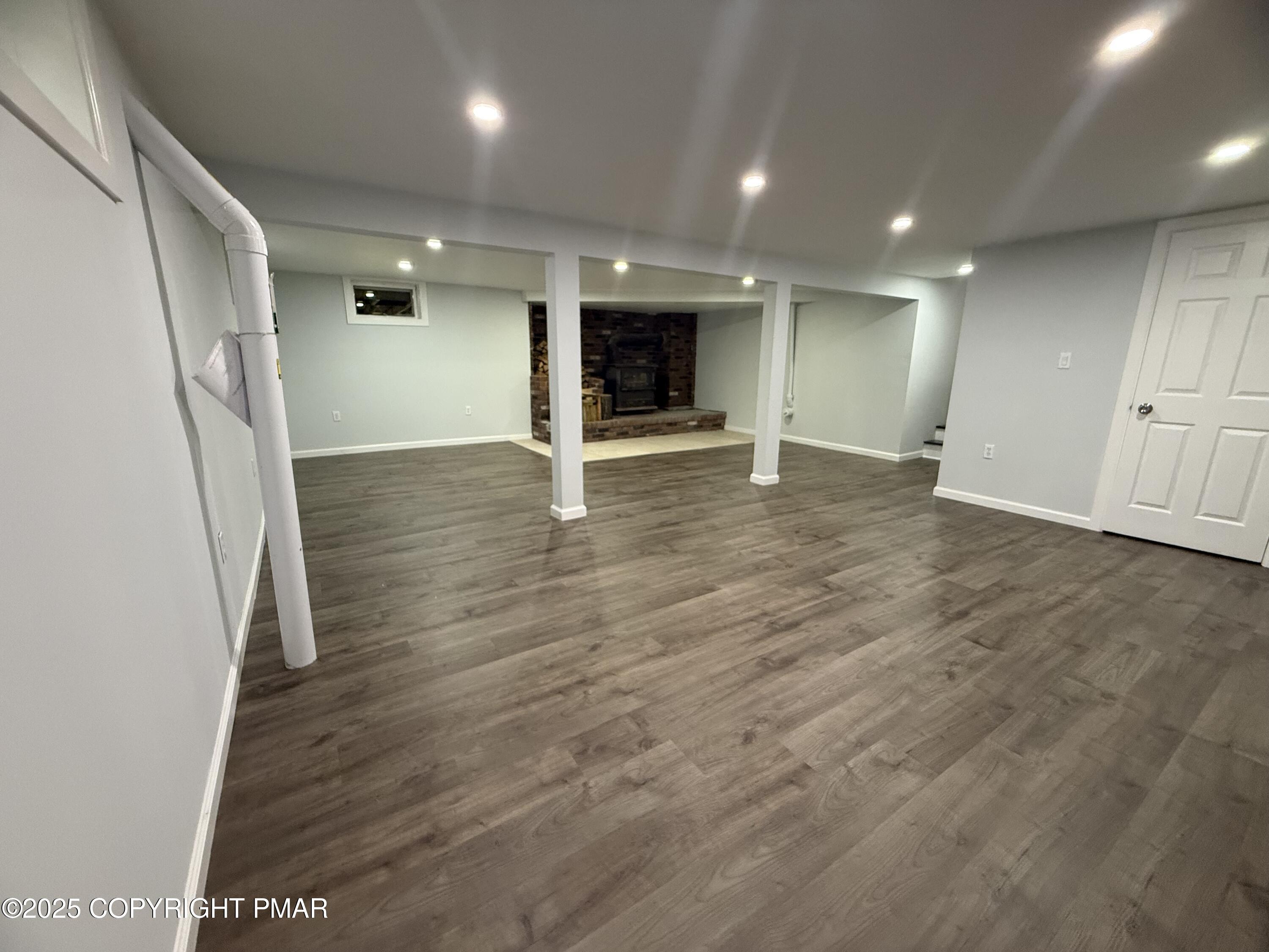 37 Seneca Road Mount Pocono, PA 18344 - Photo 39 of 46 an empty room with wooden floor and staircase