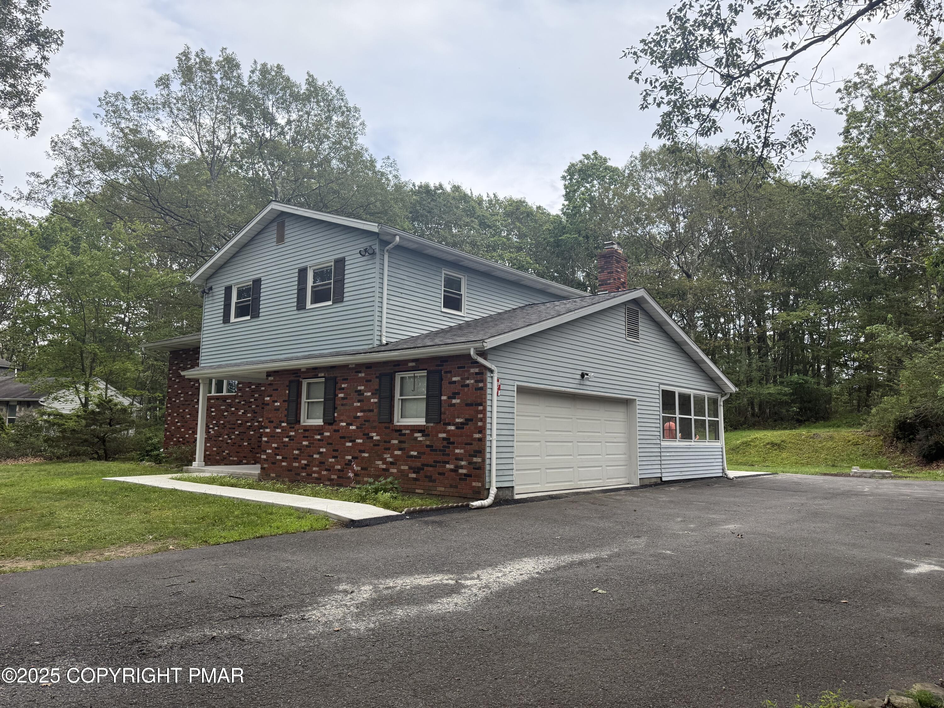 37 Seneca Road Mount Pocono, PA 18344 - Photo 4 of 46 a front view of a house with garden