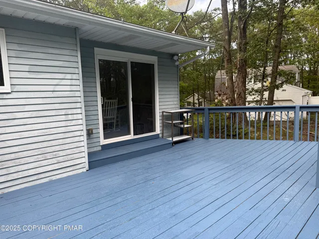a view of a house with wooden deck