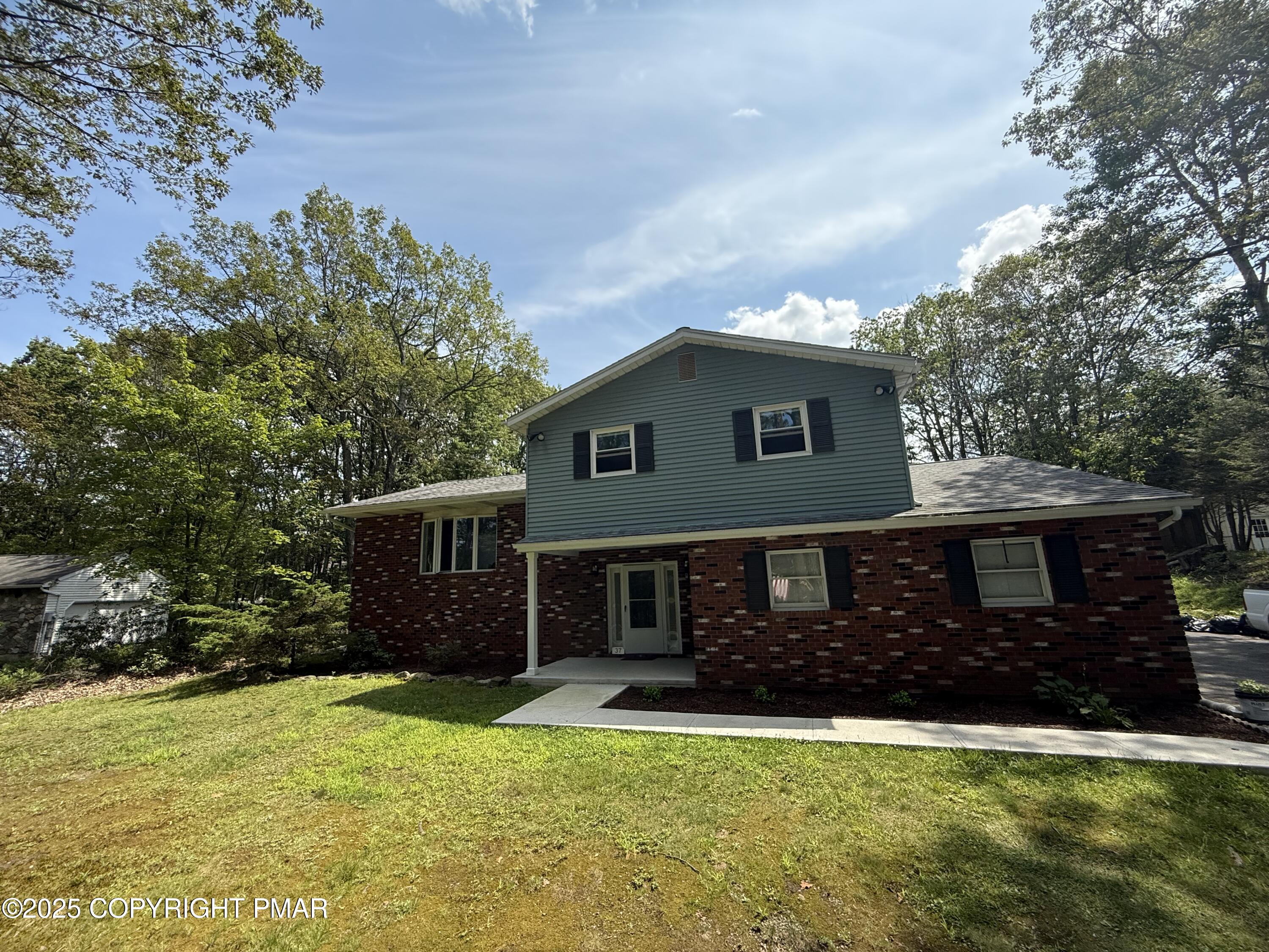 37 Seneca Road Mount Pocono, PA 18344 - Photo 45 of 46 a front view of a house with a garden