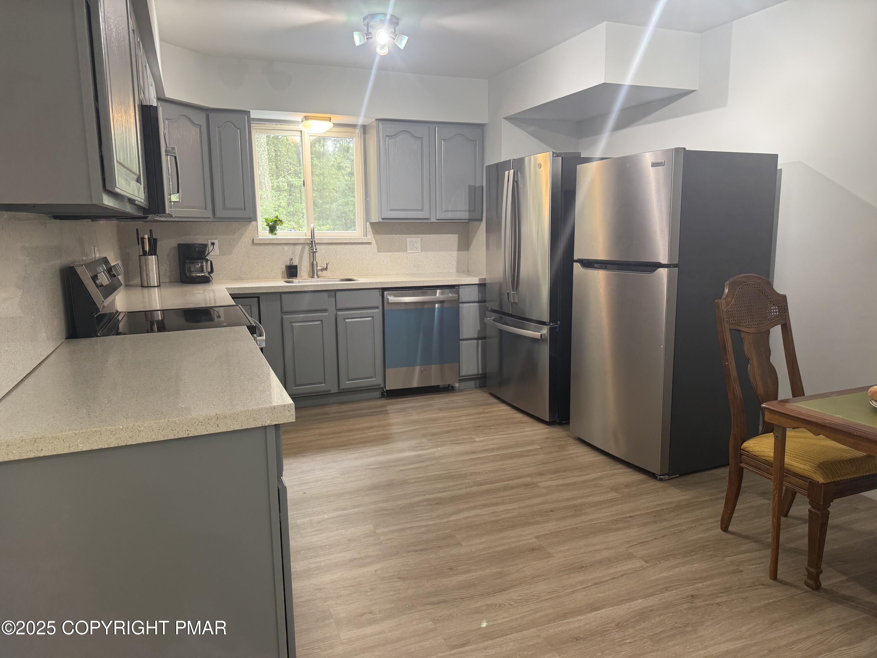 37 Seneca Road Mount Pocono, PA 18344 - Photo 8 of 46 a kitchen with a refrigerator sink and cabinets
