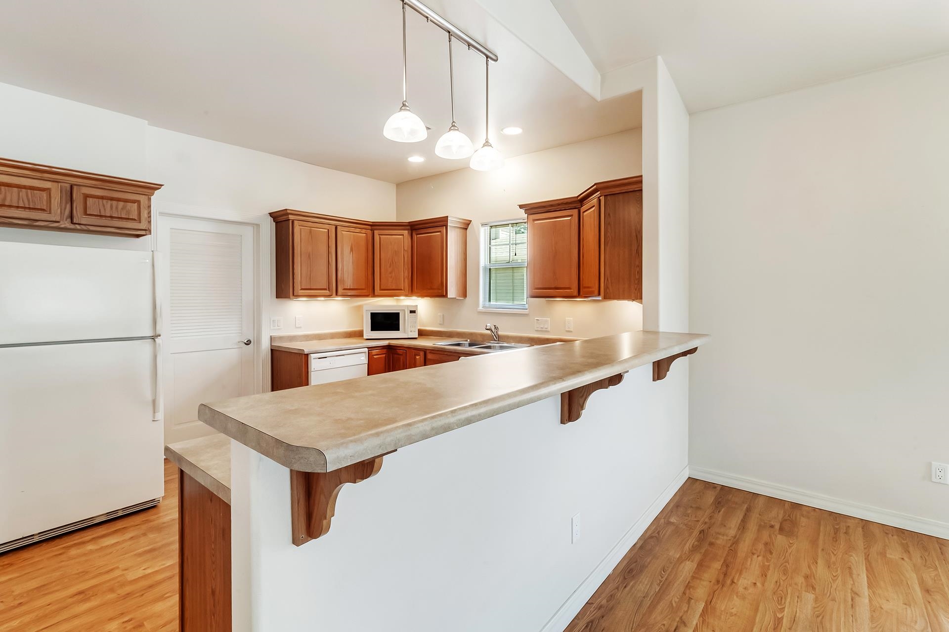 1229 Windsor Park Drive Fruita, CO 81521 - Photo 16 of 36 a kitchen with stainless steel appliances granite countertop a sink refrigerator and microwave