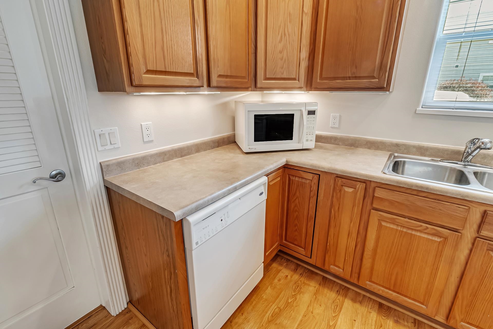 1229 Windsor Park Drive Fruita, CO 81521 - Photo 21 of 36 a kitchen with granite countertop wood cabinets and white appliances