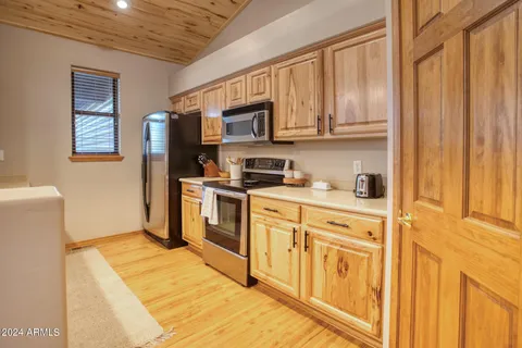 a kitchen with stainless steel appliances granite countertop a refrigerator a stove top oven a sink and dishwasher
