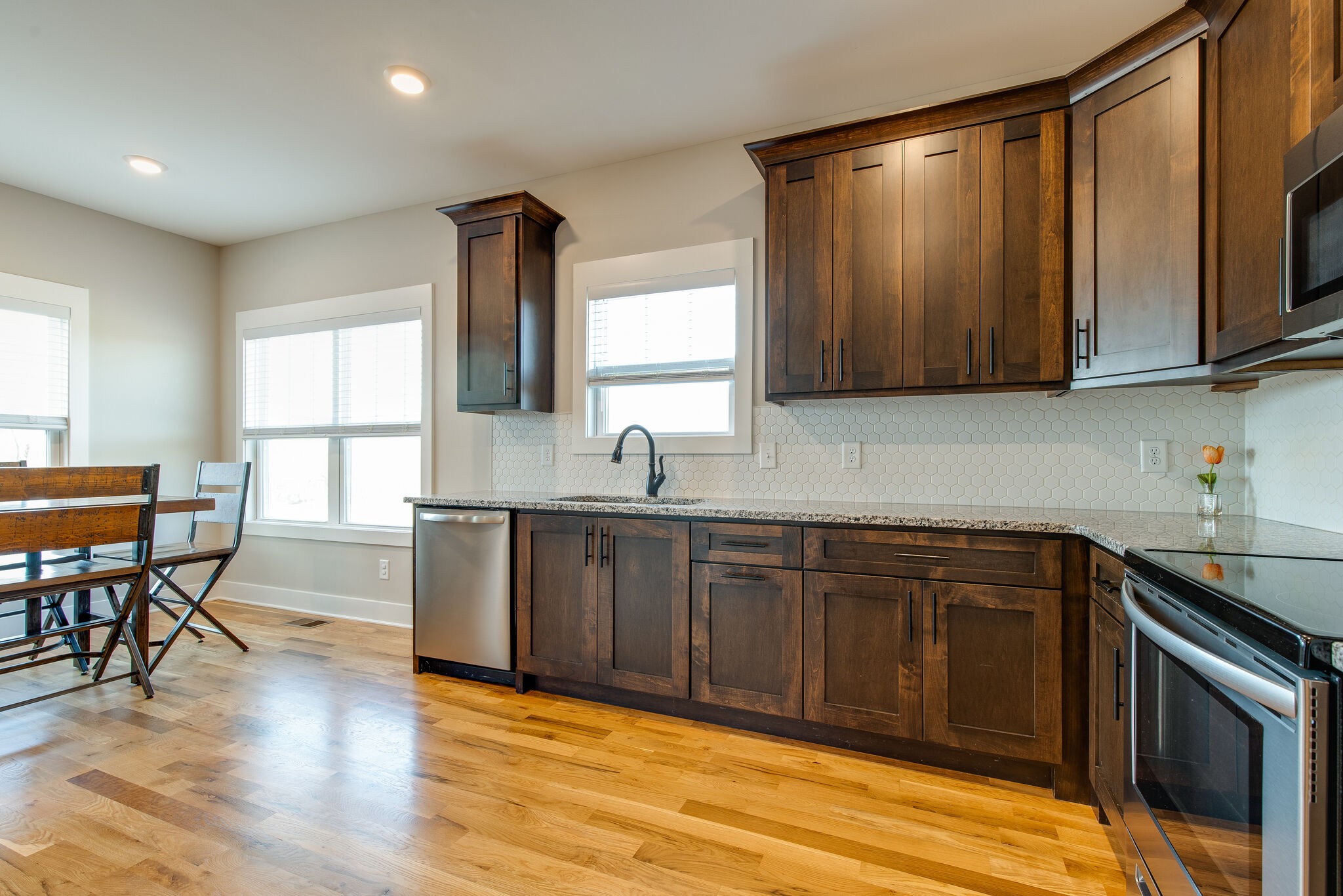 3188 Battle Creek Road Springfield, TN 37172 - Photo 12 of 49 a kitchen with stainless steel appliances granite countertop wooden cabinets a sink a stove a dining table and chairs
