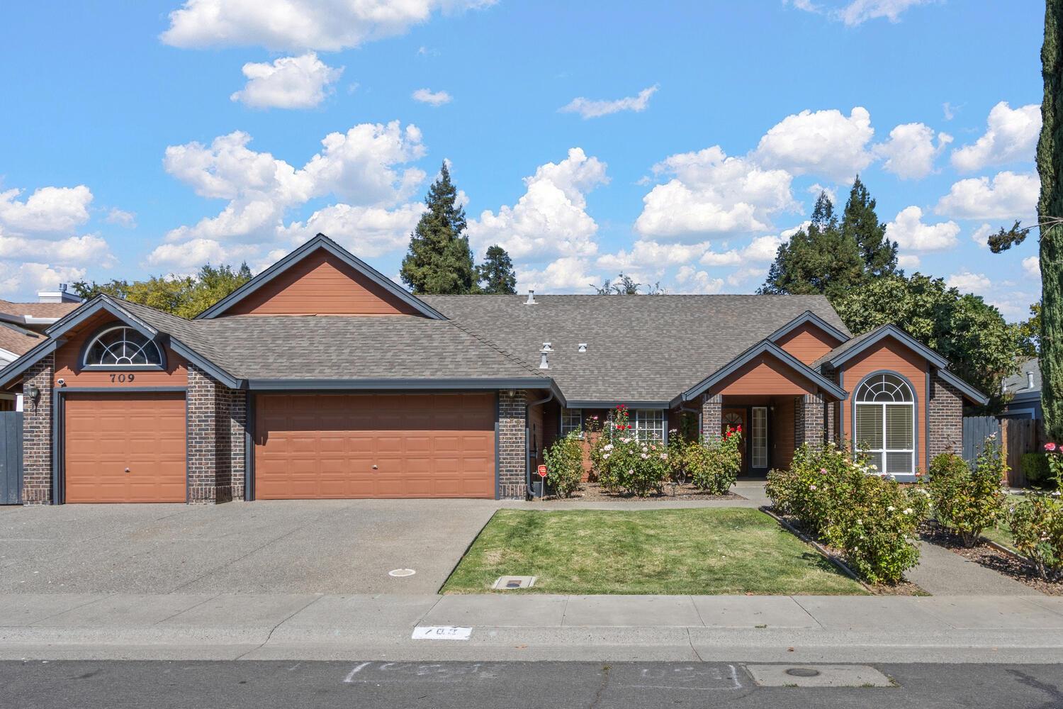 a front view of a house with garden