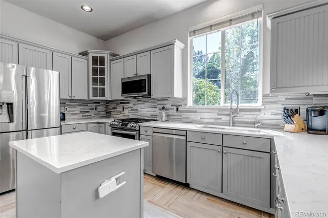 a large bed sitting in a room next to a window