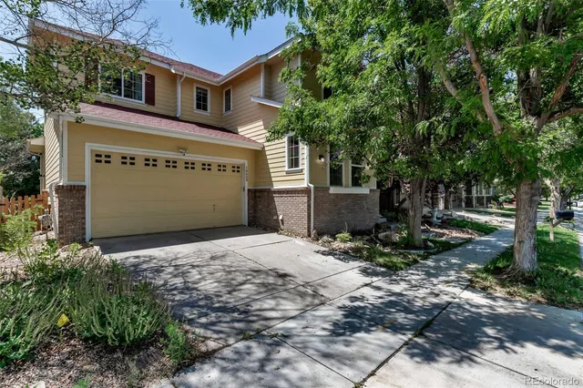 a large white bed in a room next to a window