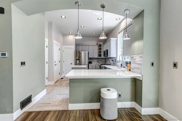 a kitchen with cabinets appliances and a sink