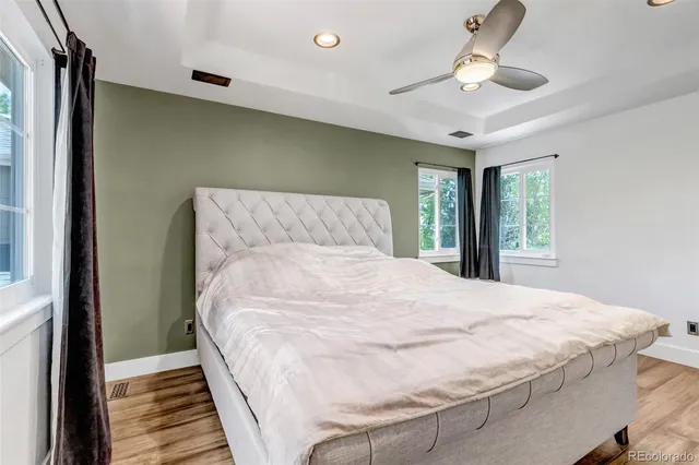 a bathroom with a granite countertop double vanity sink and mirror with bathtub