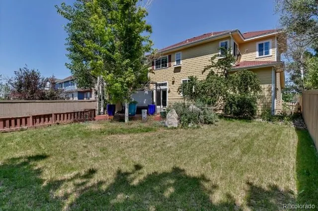 a view of a house with a yard and sitting area