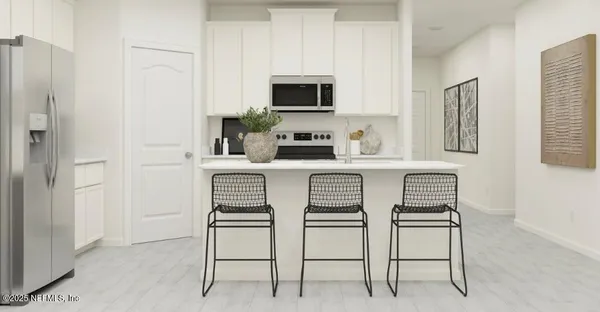 a kitchen with a refrigerator and white cabinets
