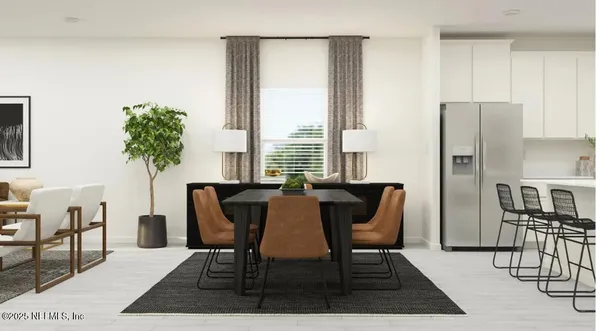 a view of a dining room with furniture and a potted plant
