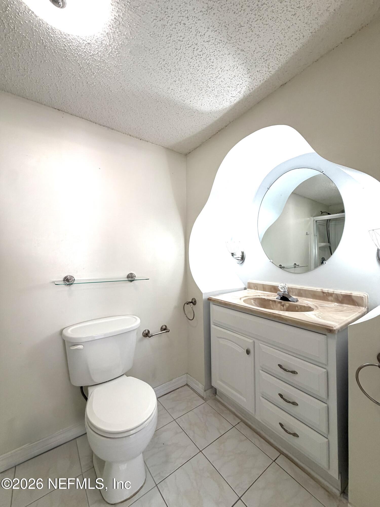 4127 Springwood Road Jacksonville, FL 32207 - Photo 20 of 63 a bathroom with a toilet a sink and mirror