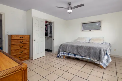 a bedroom with a bed and a dresser