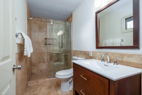 a view of a livingroom with walk in closet with wooden floor