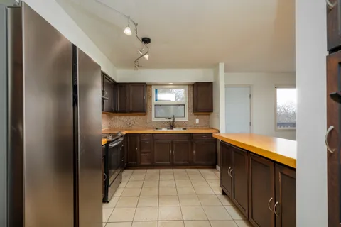 a kitchen with a sink appliances and cabinets