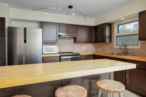 a dining room with furniture and a kitchen view