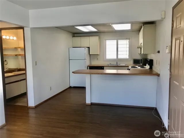 a kitchen with granite countertop a sink and a stove top oven