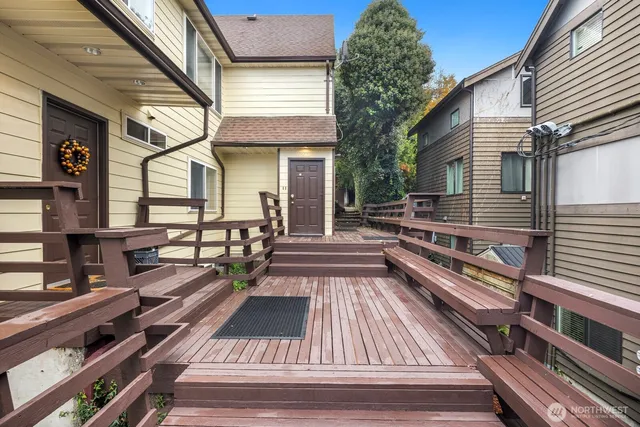 a view of a balcony with two couches and wooden floor