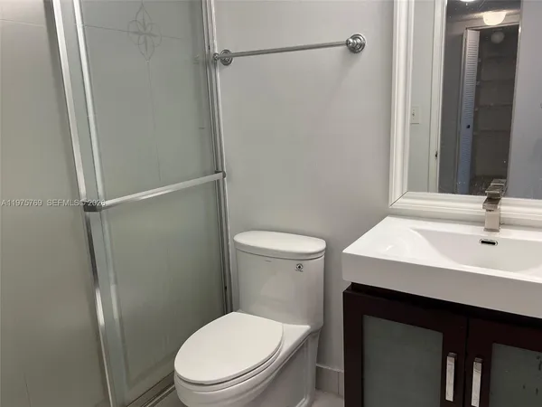 a kitchen with a sink and a mirror