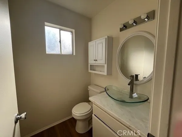a bathroom with a granite countertop toilet and a sink