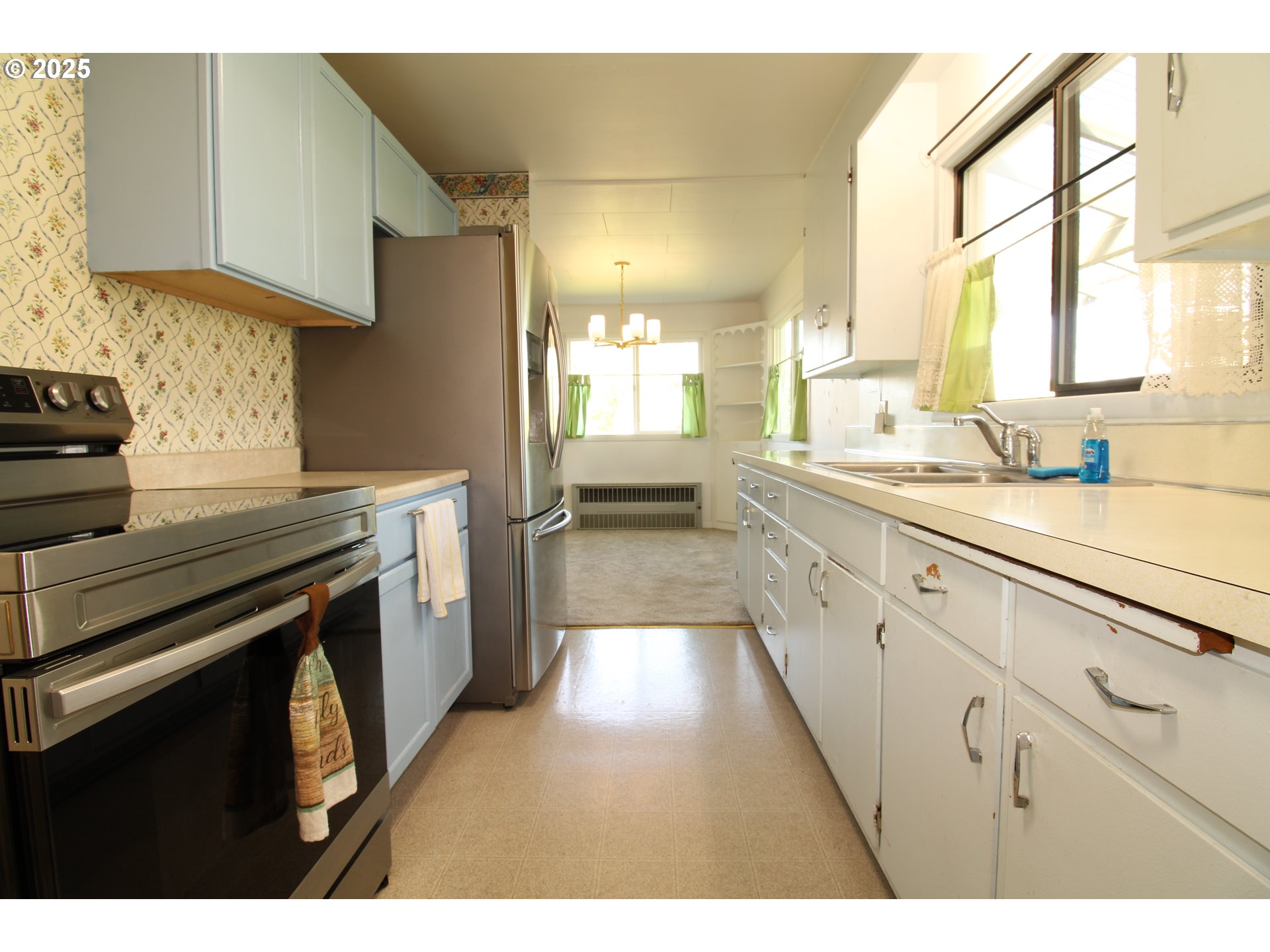 345 14th Street Springfield, OR 97477 - Photo 5 of 23 a kitchen with a sink stove and cabinets