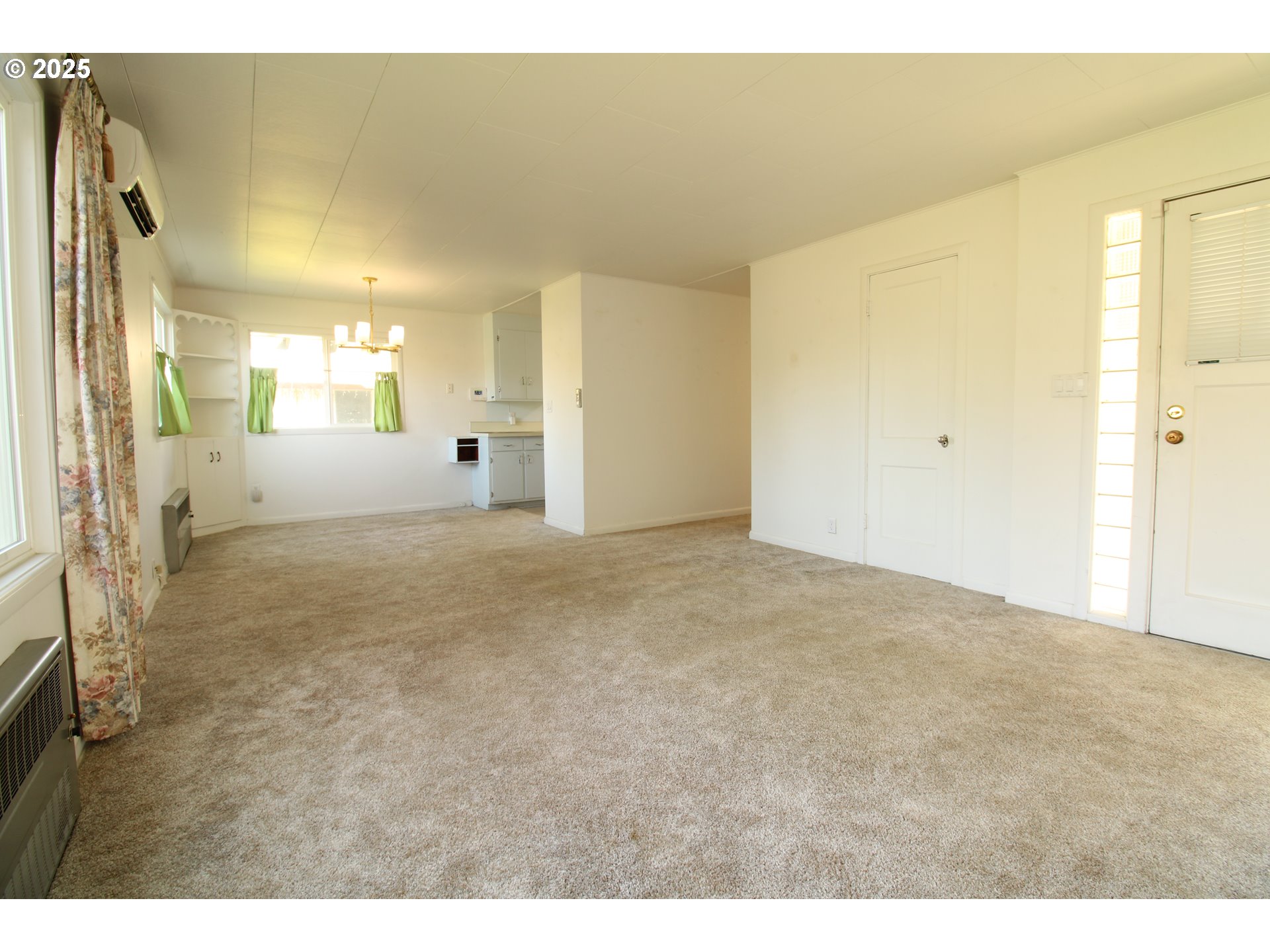 345 14th Street Springfield, OR 97477 - Photo 8 of 23 a view of a big room with wooden floor and a cabinet