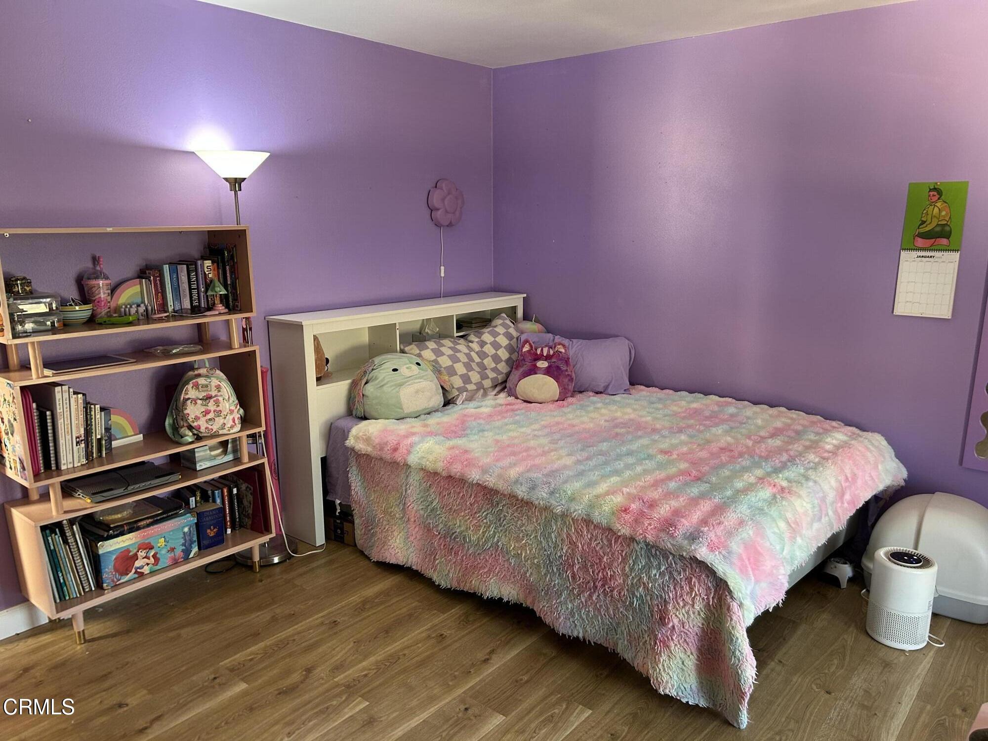 142 Geranium Way, Unit 142 Ventura, CA 93004 - Photo 12 of 23 a bedroom with a bed and a book shelf