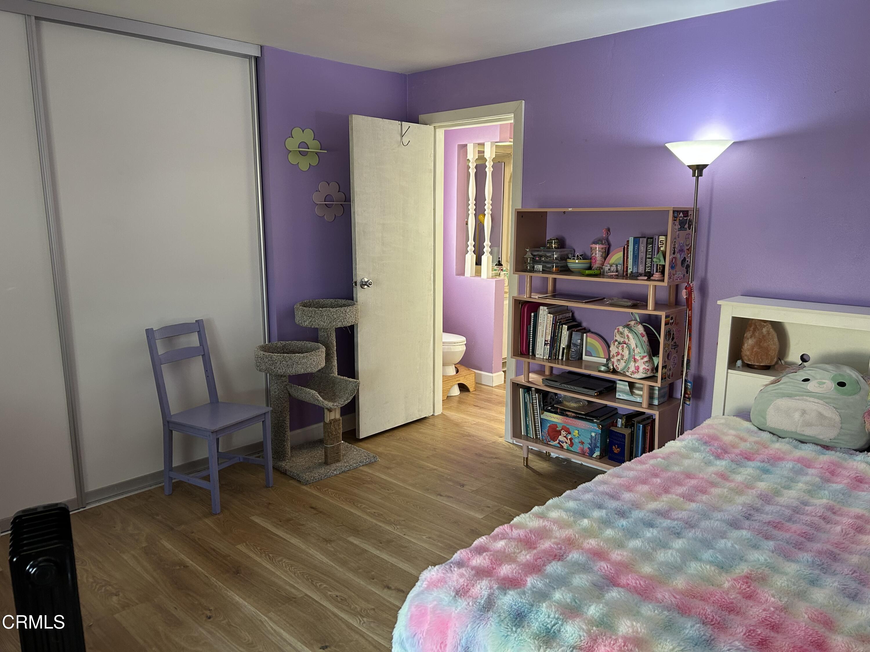 142 Geranium Way, Unit 142 Ventura, CA 93004 - Photo 14 of 23 a bedroom with a bed a table and a chair