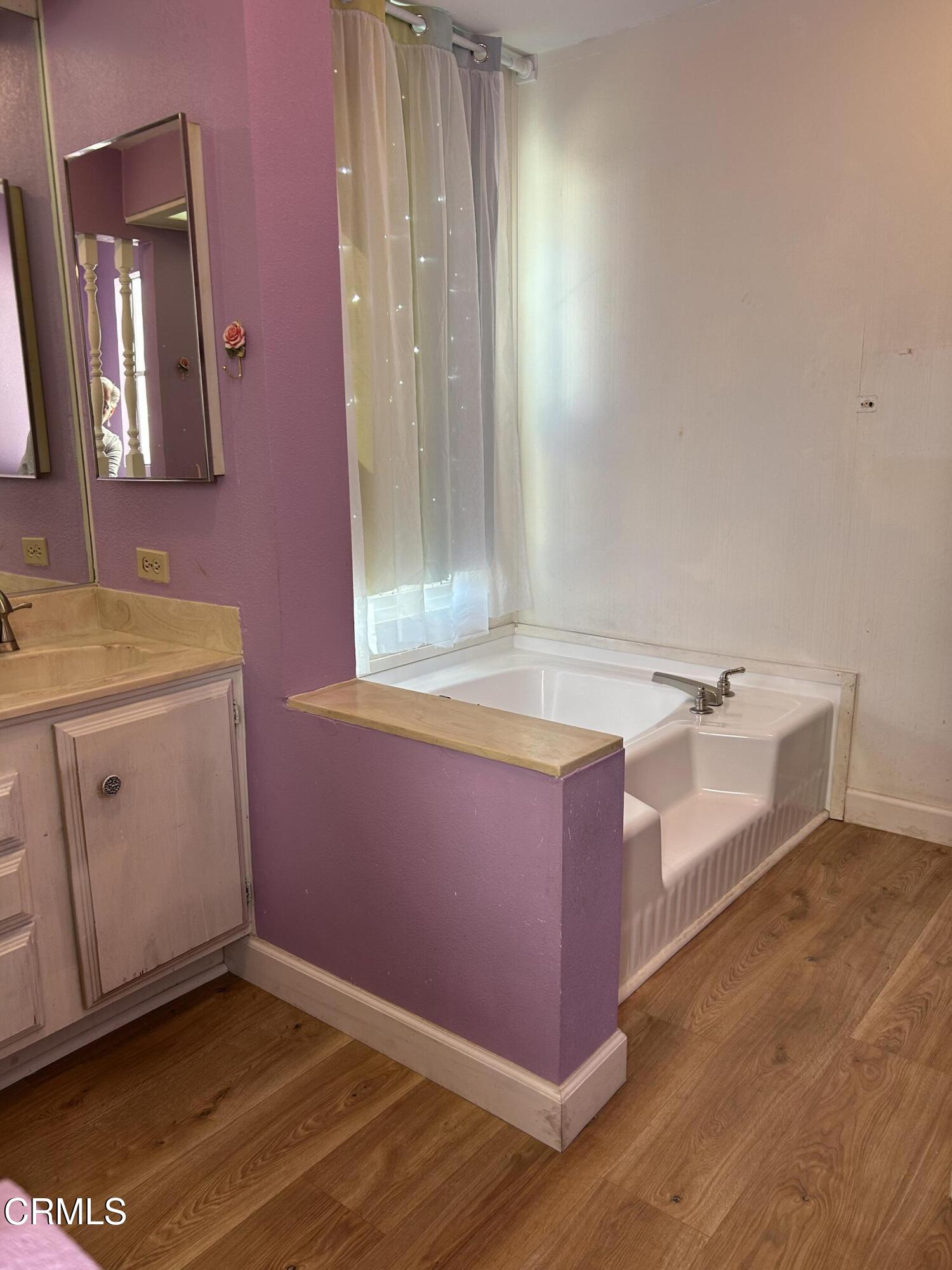 142 Geranium Way, Unit 142 Ventura, CA 93004 - Photo 16 of 23 a spacious bathroom with a tub sink and mirror