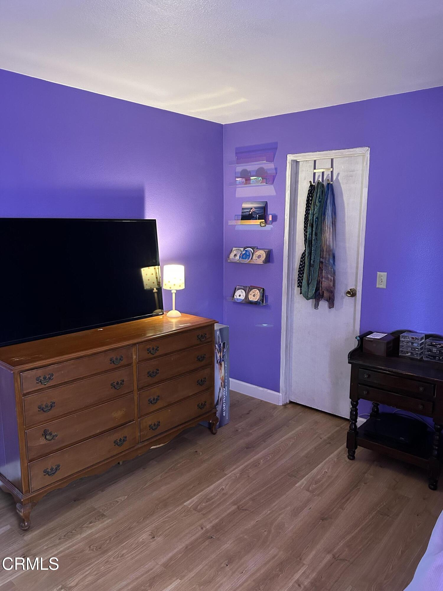 142 Geranium Way, Unit 142 Ventura, CA 93004 - Photo 17 of 23 a bed room with a bed and a television