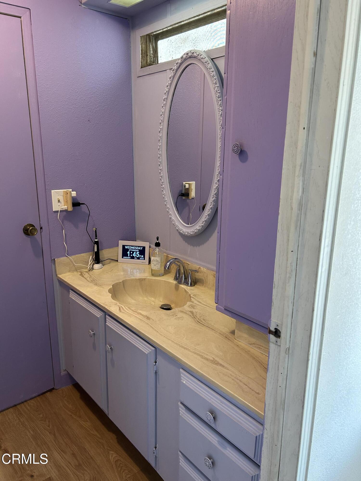 142 Geranium Way, Unit 142 Ventura, CA 93004 - Photo 10 of 23 a bathroom with a granite countertop sink and a mirror