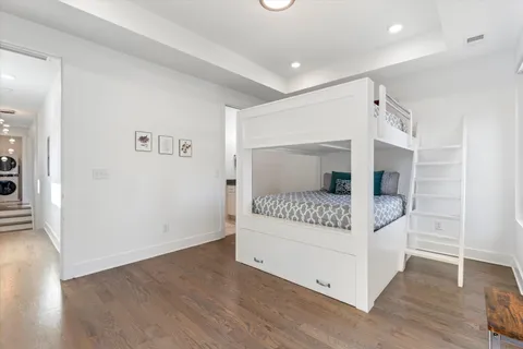 a view of bedroom with furniture and wooden floor