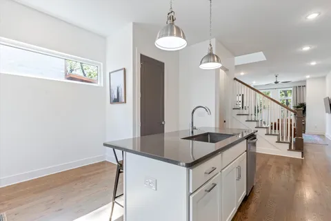 a kitchen with sink cabinets and wooden floor