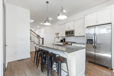 a kitchen with kitchen island a counter space and stainless steel appliances