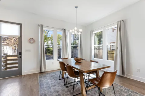 a view of a dining room with furniture window and wooden floor