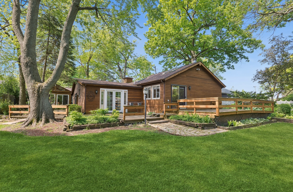 21368 West Pepper Road Lake Zurich, IL 60047 - Photo 20 of 24 a front view of house with a garden and patio