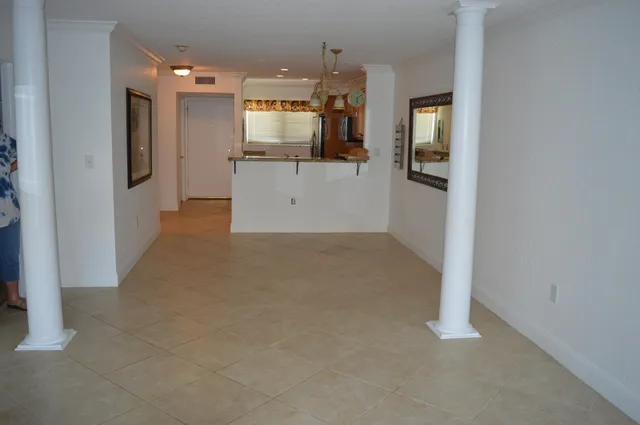 en empty room with kitchen and wooden floor
