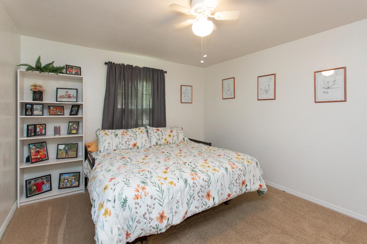 401 Fortuna Avenue Modesto, CA 95354 - Photo 16 of 43 a bedroom with a bed and a book shelf