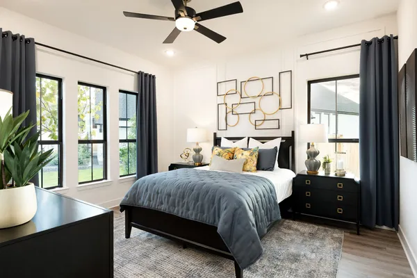 a bedroom with a large bed and a window