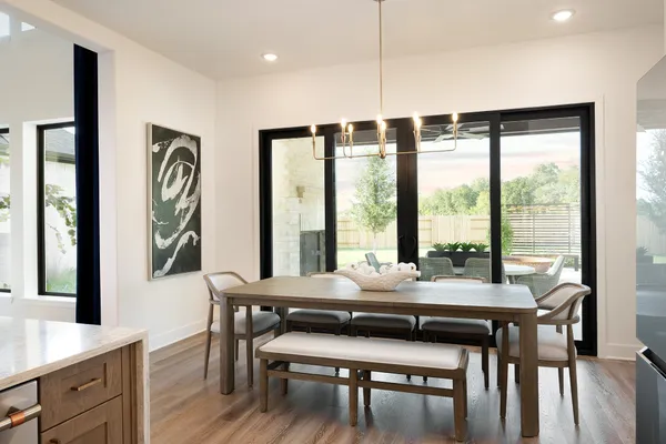 a room with pool table and windows