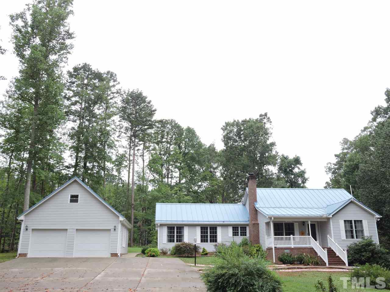 49 Epps Martin Road Roxboro, NC 27574 - Photo 1 of 25 a front view of a house with a yard and trees