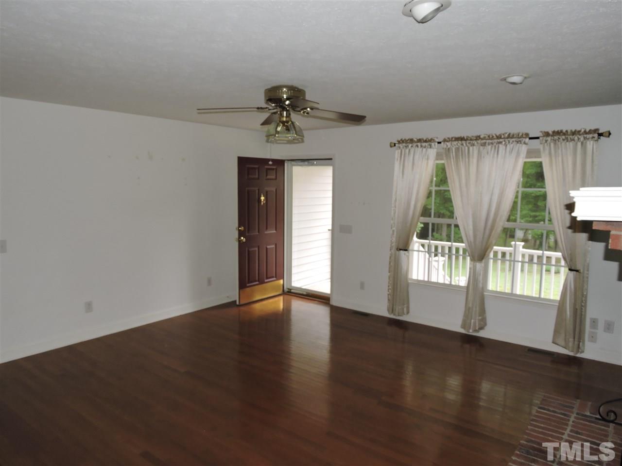 49 Epps Martin Road Roxboro, NC 27574 - Photo 2 of 25 an empty room with wooden floor and windows