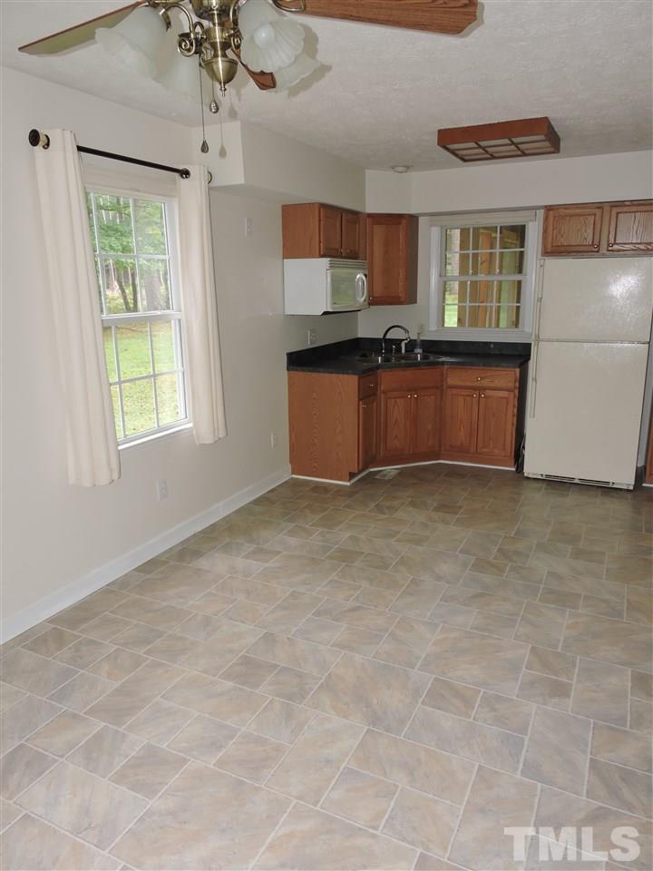 49 Epps Martin Road Roxboro, NC 27574 - Photo 11 of 25 a kitchen with granite countertop a stove a sink and a granite counter top