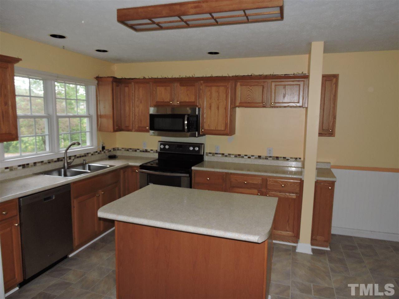 49 Epps Martin Road Roxboro, NC 27574 - Photo 4 of 25 a kitchen with a stove a sink and a refrigerator