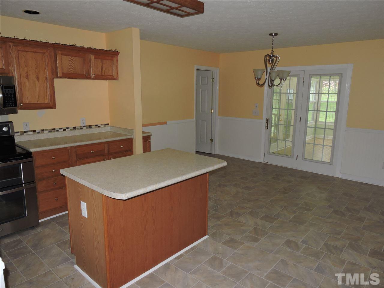 49 Epps Martin Road Roxboro, NC 27574 - Photo 5 of 25 a kitchen with a stove and a refrigerator