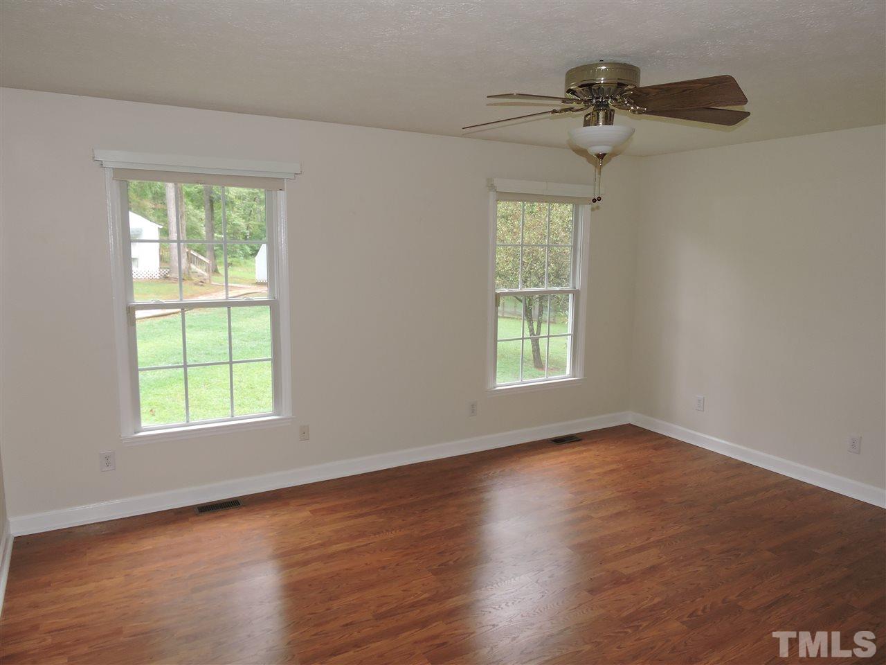 49 Epps Martin Road Roxboro, NC 27574 - Photo 6 of 25 a view of an empty room with a window and wooden floor