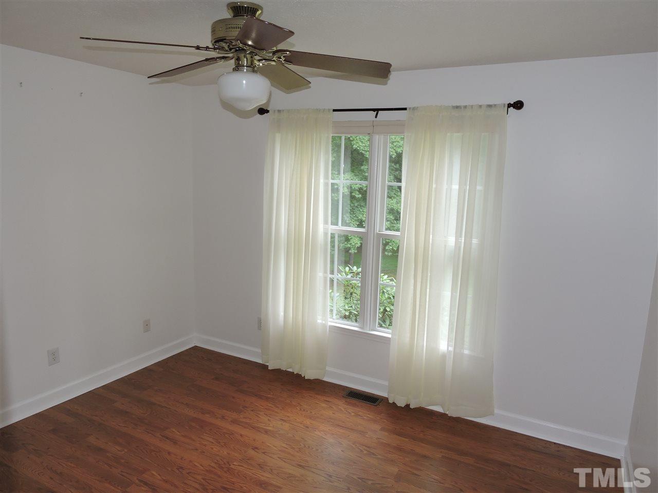 49 Epps Martin Road Roxboro, NC 27574 - Photo 7 of 25 a view of an empty room with wooden floor and a window