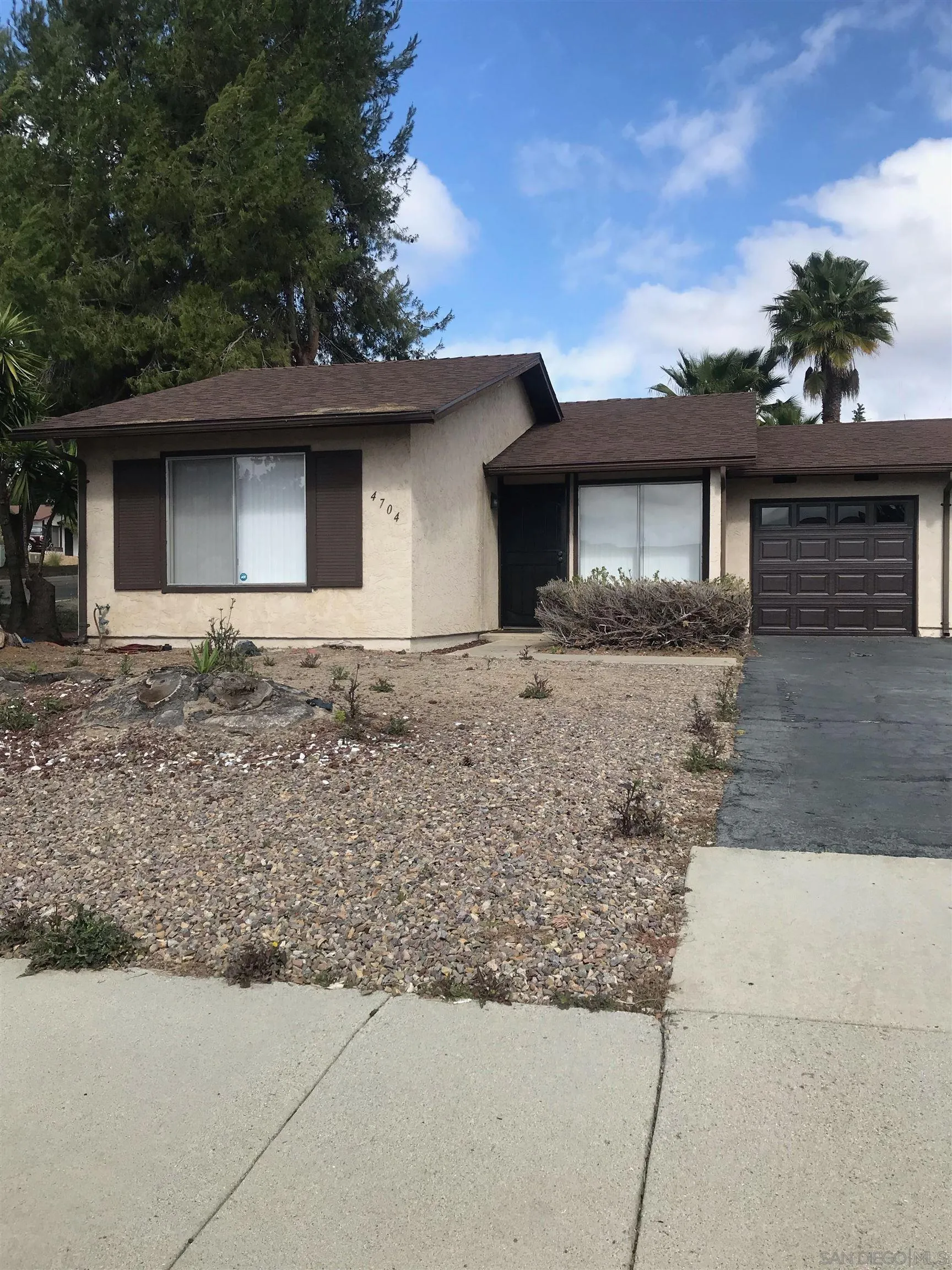 4704 Rim Rock Road Oceanside, CA 92056 - Photo 1 of 11 a front view of a house with garden